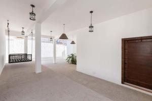 a large white room with a wooden door at Luxury & Spacious Beachfront Home Casa Espiritu in Puerto Peñasco