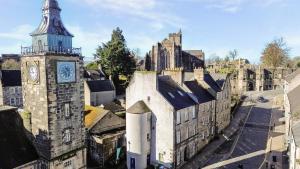 an old building with a clock tower in a city at Mar Apartment in Stirling
