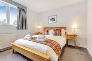 a bedroom with a large bed and a window at 3 Bed in Ullapool oc-s33063 in Ullapool