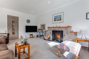 a living room with a fireplace and a tv at 3 Bed in Ullapool oc-s33063 in Ullapool
