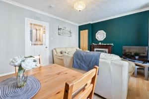a living room with a couch and a table at Mar Apartment in Stirling