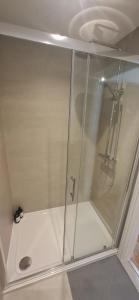 a shower with a glass door in a bathroom at Lancaster Cottage in Hawes +42 photos