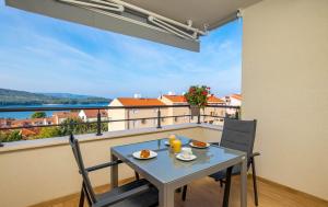 a table and chairs on a balcony with a view at Cres Sea & Sunset View in Cres +10 photos