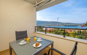 a table and chairs with a view of the water at Cres Sea & Sunset View in Cres
