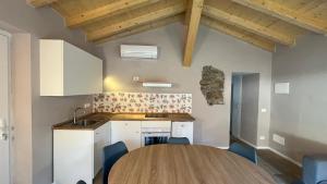 a kitchen with a wooden table in a room at Da Teo & Lisa in Vignone +11 photos