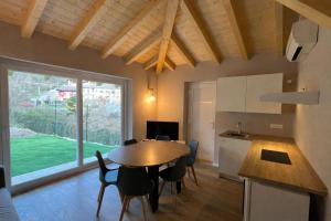 a kitchen and dining room with a table and a kitchen and a window at Da Teo & Lisa in Vignone