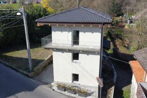 a white building with a balcony on a street at Da Teo & Lisa in Vignone