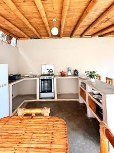 a kitchen with a table and a counter top at Casa BLU in Máncora