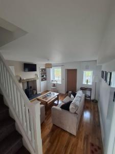 a living room with a couch and a table at Lancaster Cottage in Hawes