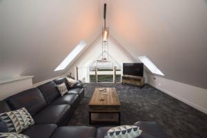 a living room with a couch and a tv at Taigh Rona in Tarbert