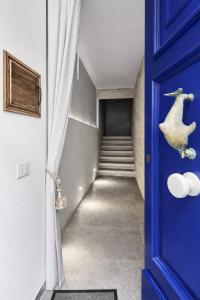 a blue door leading to a hallway with stairs at The Opal - V3 in Valletta
