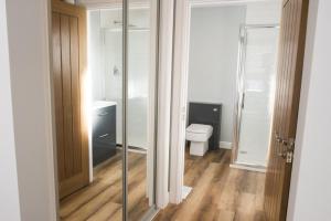 a bathroom with a toilet and a glass door at Taigh Rona in Tarbert +45 photos