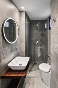 a bathroom with a sink and a shower at The Opal - V3 in Valletta +27 photos