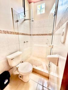 a bathroom with a toilet and a shower at Tourist House Suites Otavalo in Otavalo +38 photos