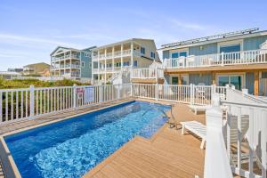 a swimming pool on a deck next to a building at Carolina Clipper West by Emerald Isle Realty in Emerald Isle