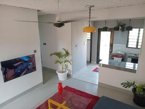 a living room with a tv and a kitchen at TN Apartments deviat in Diani Beach