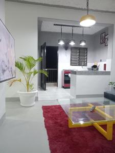 a living room with a glass table and a kitchen at TN Apartments deviat in Diani Beach +19 photos