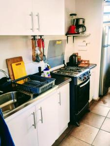 a kitchen with a stove and a sink at CHEZ GERARDo ! in La Serena +15 photos