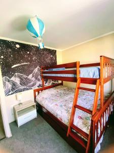 a bedroom with two bunk beds with a rocket mural at CHEZ GERARDo ! in La Serena