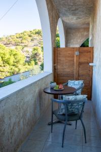 a table and chairs on a balcony with a view at Agistri Island Dream in Skala