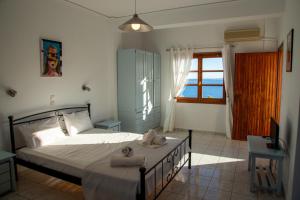 a bedroom with a bed with towels on it at Agistri Island Dream in Skala