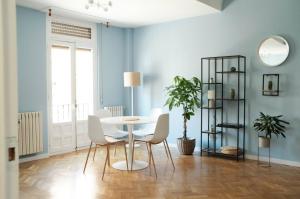 a dining room with blue walls and a table and chairs at BaruHaus GRUPOS Rua Legio in León