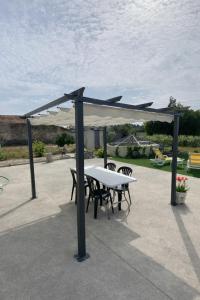 a table and chairs under a canopy on a patio at Casa da Tia in Poutena