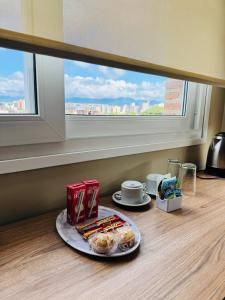 a plate of food on a table in front of a window at Terra Alta Suites in Salta