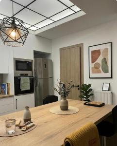 a kitchen with a wooden table with a refrigerator at Anna's sea view apartment in Kánithos +9 photos