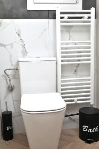 a bathroom with a white toilet in a room at X N Skiathos in Skiathos +28 photos