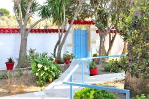 a blue staircase in front of a house with trees at X N Skiathos in Skiathos