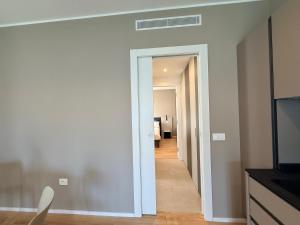 a hallway with a door leading to a living room at LA TERRAZZA APARTMENTS - Sand & Green Apartments - DeltadelPo in Porto Viro