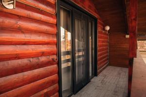 a hallway of a house with a wooden wall at Zen Home in Mihai Viteazu