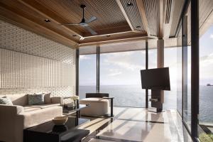 a living room with a view of the ocean at Conrad Koh Samui in Taling Ngam Beach