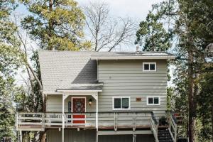 a house with a wrap around porch at Little Chip Lake Arrowhead Cabin in Lake Arrowhead