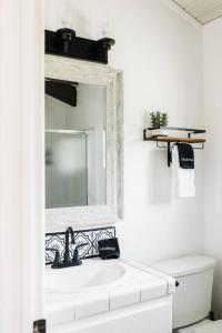 a bathroom with a white sink and a mirror at Little Chip Lake Arrowhead Cabin in Lake Arrowhead +61 photos