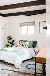 a bedroom with a large bed and a table at Little Chip Lake Arrowhead Cabin in Lake Arrowhead