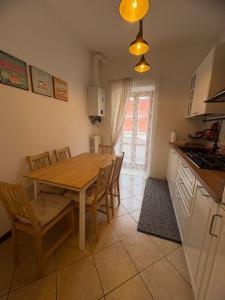 a kitchen and dining room with a wooden table and chairs at A casa di Maria in Sulmona