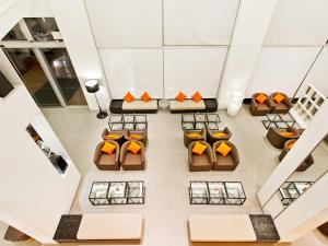 
a dining room table filled with oranges and fruit at Ibis Pattaya - SHA Extra Plus in Pattaya
