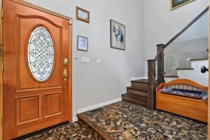 a wooden door in a room with a staircase at River Rock House-Deck-BBQ-Forest Trails & Views! in South Lake Tahoe