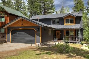 a house with a garage with a carport at River Rock House-Deck-BBQ-Forest Trails & Views! in South Lake Tahoe