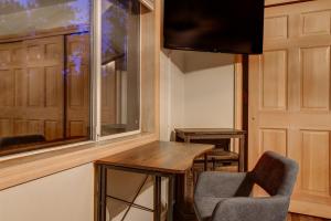 a room with a table and two chairs and a window at River Rock House-Deck-BBQ-Forest Trails & Views! in South Lake Tahoe