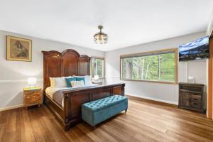 a bedroom with a large bed and a window at River Rock House-Deck-BBQ-Forest Trails & Views! in South Lake Tahoe