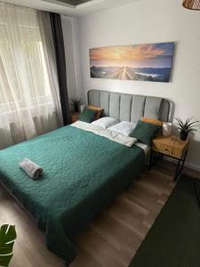a bedroom with a bed with a painting on the wall at Buda Side Comfort in Budapest