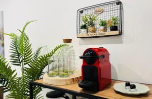 a red toaster sitting on a table with plants at Buda Side Comfort in Budapest