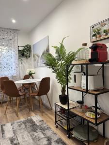 a room with a table and chairs and a plant at Buda Side Comfort in Budapest
