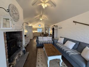 a living room with a blue couch and a fireplace at Blue Bay, The Bay, 2 bedrooms with ensuites, parking bay, 2 dogs welcome in Filey