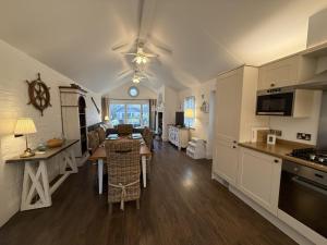 a kitchen and living room with a table and chairs at Blue Bay, The Bay, 2 bedrooms with ensuites, parking bay, 2 dogs welcome in Filey
