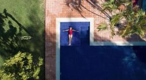 a woman is walking down a door into a pool at Hato San Pablo in Guayabal