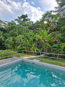 an outdoor swimming pool with trees in the background at MAYU PATANPI Amazon Lodges in Tarapoto +52 photos